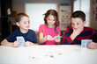 © Gemütlichkeit - kids playing cards