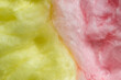 Bicolor cotton candy (fairy floss) as a background. Yellow and pink cotton candy full frame