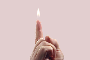 Poster - Shot of a human finger pointing up with candle flame on the top isolated on a bright backgro