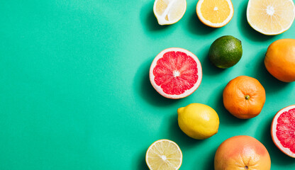 Citrus fruit on green table with copy space