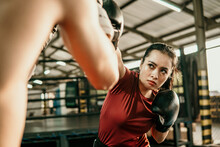 Young Woman Boxer Doing Exercise Hitting Punching Competing With Her Opponent At Boxing Camp