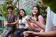© Odua Images - group of friends relax and drink together in the garden
