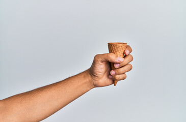 Wall Mural - Hand of hispanic man holding biscuit cone over isolated white background.