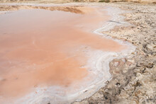 Edge Of Pink Lake Close Up With White Salt Edges In The Sand In Al Rams, United Arab Emirates In Ras Al Khaimah Emirate.