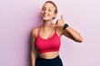 © Krakenimages.com - Beautiful caucasian woman wearing sportswear smiling doing phone gesture with hand and fingers like talking on the telephone. communicating concepts.