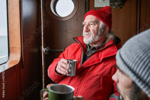 Senior bearded man looking at the window