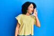 © Krakenimages.com - Young african american girl wearing casual clothes shouting and screaming loud to side with hand on mouth. communication concept.
