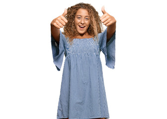 Beautiful caucasian teenager girl wearing summer dress approving doing positive gesture with hand, thumbs up smiling and happy for success. winner gesture.