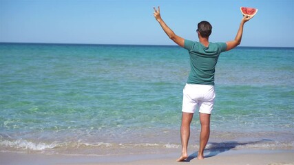 Wall Mural - Young man on the white beach on vacation