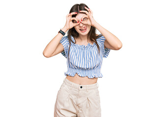 Sticker - Young beautiful caucasian girl wearing casual clothes doing ok gesture like binoculars sticking tongue out, eyes looking through fingers. crazy expression.