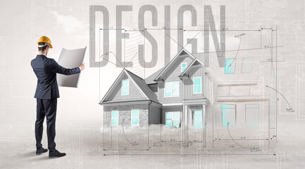  Young engineer holding blueprint with DESIGN inscription, house planning concept