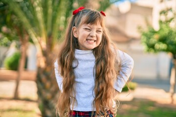 Adorable caucasian child girl  smiling happy standing at the park