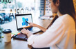 © GalakticDreamer - Cropped image on caucasian female student in casual wear using laptop computer for learning online course, rear view of businesswoman checking graphic chart of trade on web page on remote job