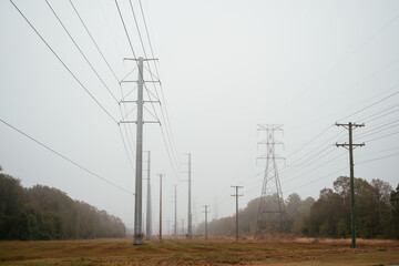 High voltage electric power line in the morning fog