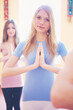 © Myshkovskyi - Two women practicing yoga indoors in the morning.