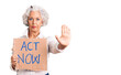 © Krakenimages.com - Senior grey-haired woman holding act now banner with open hand doing stop sign with serious and confident expression, defense gesture