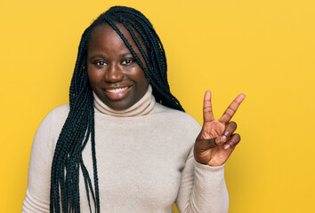 Sticker - Young black woman with braids wearing casual winter sweater smiling with happy face winking at the camera doing victory sign. number two.