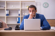 © Elnur - Young sick businessman employee suffering at workplace