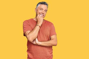 Poster - Handsome middle age man wearing casual clothes looking confident at the camera with smile with crossed arms and hand raised on chin. thinking positive.