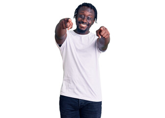 Canvas Print - Young african american man with braids wearing casual white tshirt pointing to you and the camera with fingers, smiling positive and cheerful