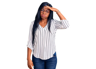 Poster - Young african american woman wearing casual clothes and glasses worried and stressed about a problem with hand on forehead, nervous and anxious for crisis