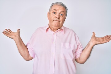 Canvas Print - Senior grey-haired man wearing casual clothes clueless and confused with open arms, no idea and doubtful face.