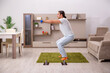 © Elnur - Young man doing sport exercises at home