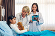 © Art_Photo - Smiling woman doctor service help support discussing and consulting talk to little girl patient give teddy bear and check up information in hospital