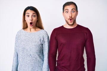 Wall Mural - Beautiful couple wearing casual clothes scared and amazed with open mouth for surprise, disbelief face