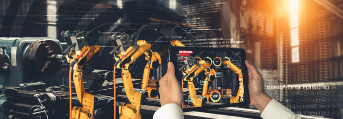 Engineer controls robotic arms by augmented reality industry technology application software. Smart robot machine in future factory working in concept of Industry 4.0 or 4th industrial revolution.