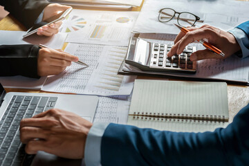 Fototapete - businessman use calculator and computer for  meeting with team accountant on desk in office. finance and accounting concept