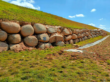 Natural Boulders Are Used As Retaining Walls Of Ground Banks That Have Been Embanked. Other Slopes Are Planted With Grass To Prevent Erosion Caused By Rain.
