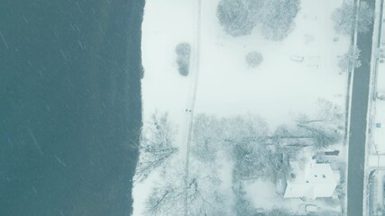 Poster - Top down perspective on the shore of Lake Ammersee in snow. Drone footage of an icy winter day at the mountain lake near Munich.