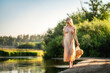 A model in a translucent dress walks along the river