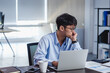 © weedezign - asian businessman get stress and thinking when working with laptop on desk at modern office.business fail concept.man rest hand on chin on table when stuck out of idea