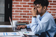 © weedezign - asian businessman get stress and headache when working with laptop on desk at modern office.business fail concept.man caught eye when overworked..