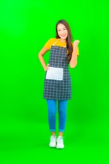 Portrait beautiful young asian woman wear apron with action on green background