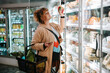 © Jacob Lund - Woman shopping groceries in supermarket