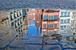 Reflection of some historic building of Frankfurt`s old city in a puddle of water