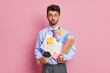 © wayhome.studio  - Unhappy skilled man analyst feels worried about deadline and much paper work looks surprisingly at camera as receives new task from boss has coffee break dressed in formal outfit poses indoor