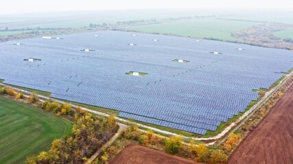 Wall Mural - Power plant using renewable solar energy. Aerial UHD 4K drone realtime video, shot in 10bit HLG and colorized