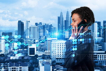 Wall Mural - Attractive black businesswoman trader processing conference call to forecast the capital market behavior. Concept of trading strategy. Forex chart. Kuala Lumpur. Double exposure.