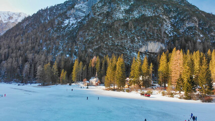 Wall Mural - Braies Lake blotted in winter, aerial view from drone, Italian Alps