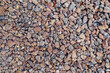 Background of natural grey granite crushed stone, macadam. Macro photo of texture of broken stone or rubble with place for text. Crushed rock. Construction Materials. Textures.