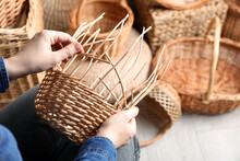 Woman Weaving Wicker Basket Indoors, Closeup View