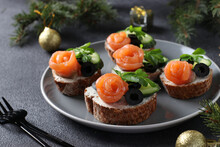 Sandwiches With Salmon, Cucumber, Cream Cheese And Black Olives On Gray Background. Homemade Holiday Snack.