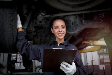 Wall Mural - Female auto mechanic work in garage, car service technician woman check and repair customer car at automobile service center, inspecting car under body and suspension system, vehicle repair service sh