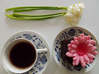 Valentine day, cup of coffee, bouquet of snowdrops flower and chocolate muffin, from above