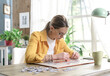© StockPhotoPro - Woman sitting at desk and solving a puzzle