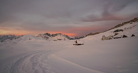 beautiful sunrise in the Swiss alps on a winter day surrounded by snow and mountains in the idyllic place Melchsee-Frutt, Switzerland